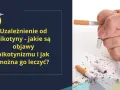 Dłoń miażdży papierosy, symbolizując walkę z uzależnieniem od nikotyny i objawami nikotynizmu.