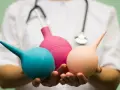 Dłoń trzymająca trzy irygatory w kolorach: niebieskim, różowym i beżowym.